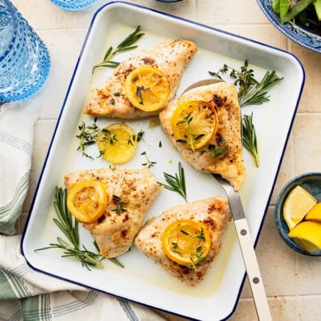 Square overhead shot of an easy baked lemon chicken recipe on a platter.