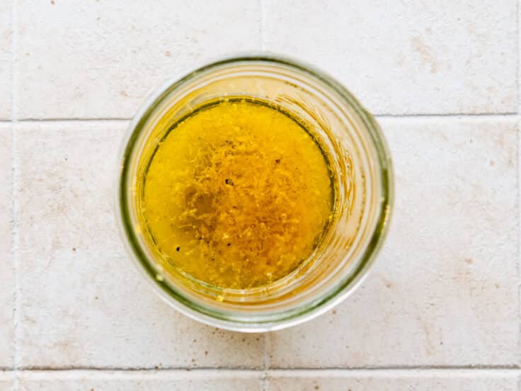 Process shot showing how to make the lemon sauce for a baked lemon chicken recipe.