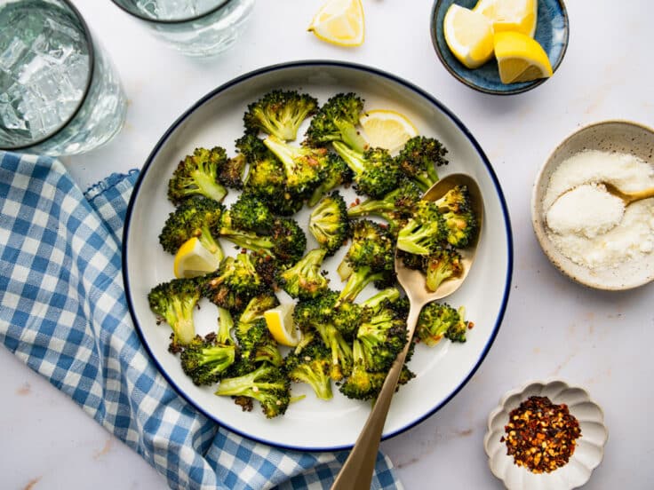 Horizontal overhead shot of a bowl of baked broccoli and garlic.