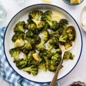 Square overhead shot of a bowl of garlic roasted broccoli.