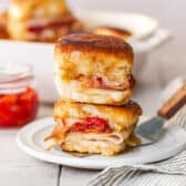 Square side shot of Kentucky hot brown sliders on a white plate.