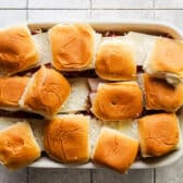 Process shot showing how to assemble and arrange hot brown sliders.