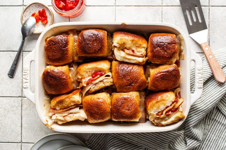 Horizontal overhead shot of a pan of baked hot brown sliders.