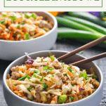 Front shot of egg roll in a bowl with text title box at the top