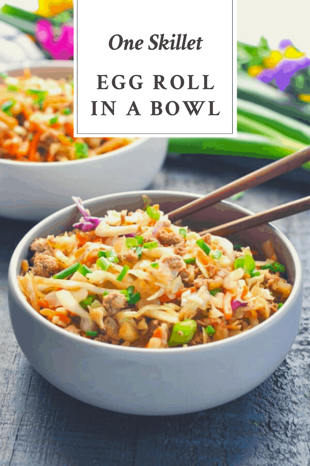 Front shot of a gray bowl full of egg roll in a bowl with text title box at the top