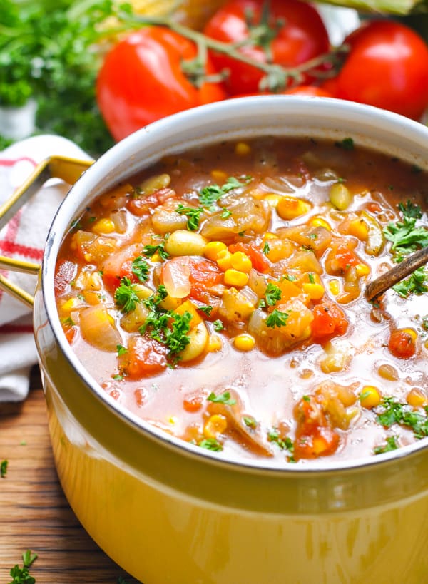 A close up of summer vegetable soup in a large pot