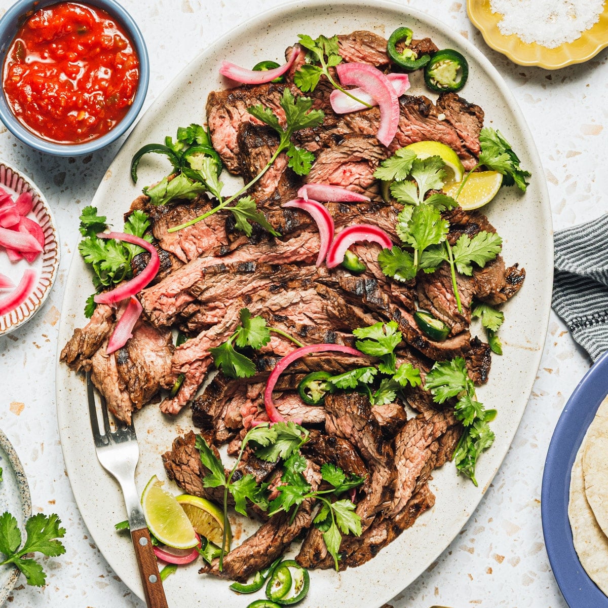Square overhead image of an easy carne asada recipe served on a white platter.