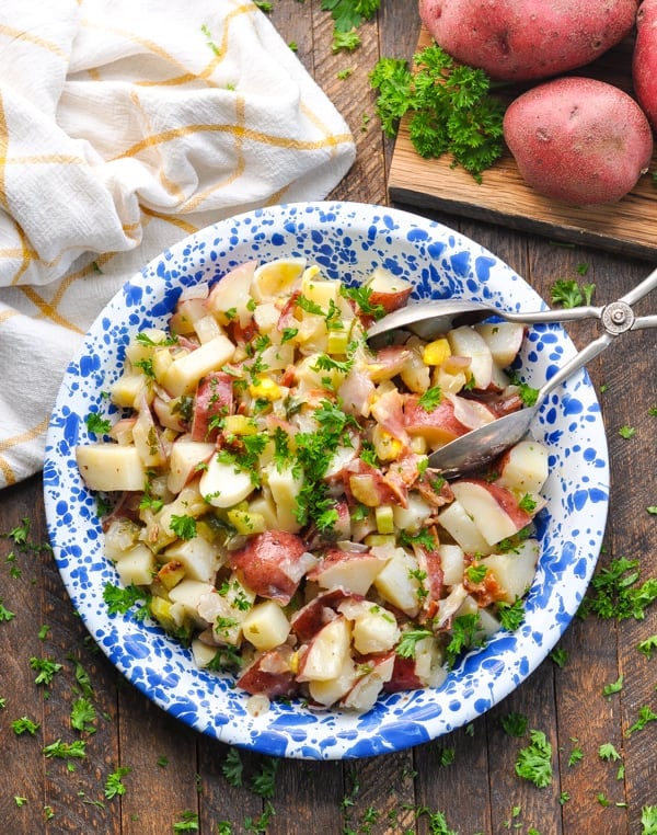 For potluck season, this German Potato Salad made with red potatoes and bacon is a crowd pleasing side dish!