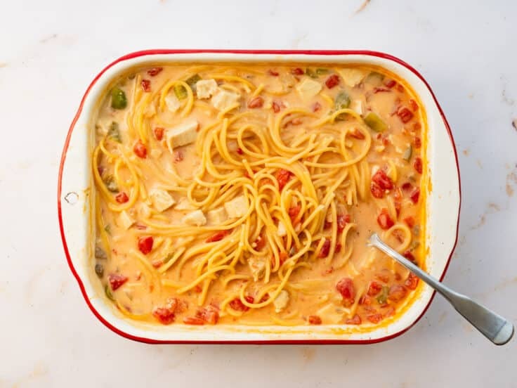 Stirring the chicken spaghetti bake after it's been in the oven.