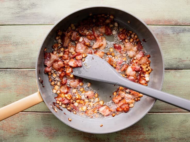Cooking bacon in a skillet.