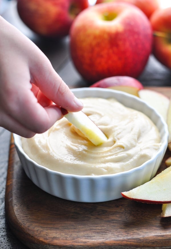 Dipping apple slices in cream cheese fruit dip