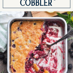 Overhead shot of a pan of traditional blackberry cobbler with text title box at top