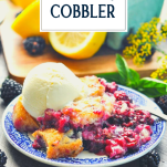 Plate of fresh blackberry cobbler with vanilla ice cream and text title overlay