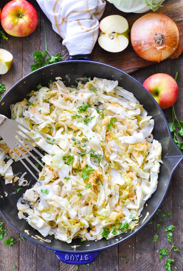 Fried cabbage with apples and onions in cast iron skillet