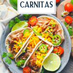 Overhead shot of slow cooker carnitas with text title overlay