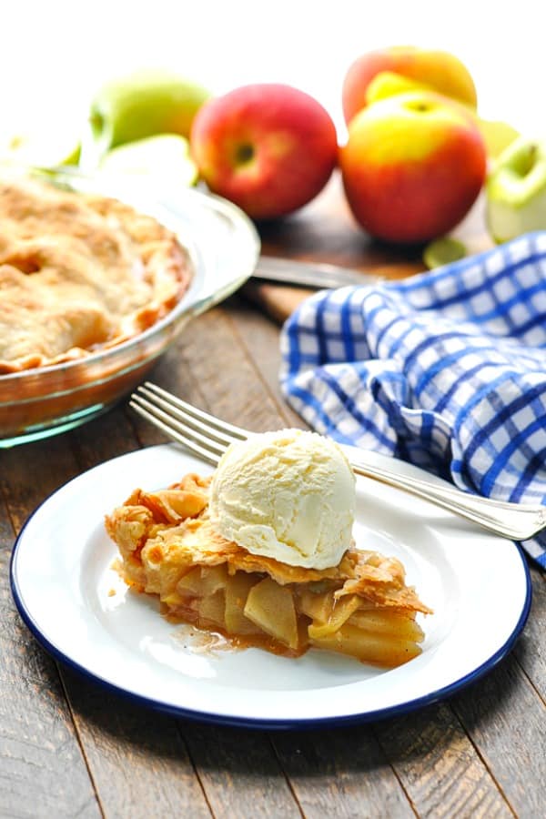 Slice of Mom's Easy Apple Pie with vanilla ice cream on a plate.