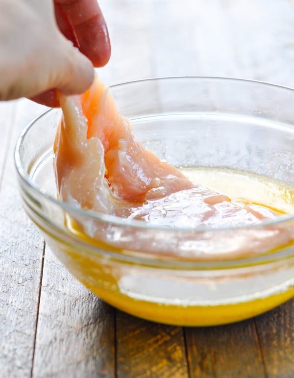 Dipping chicken in melted butter