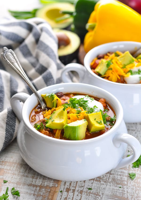 Bowl of taco soup with toppings