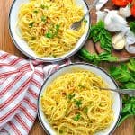 Overhead image of two bowls of spaghetti aglio e olio with text overlay