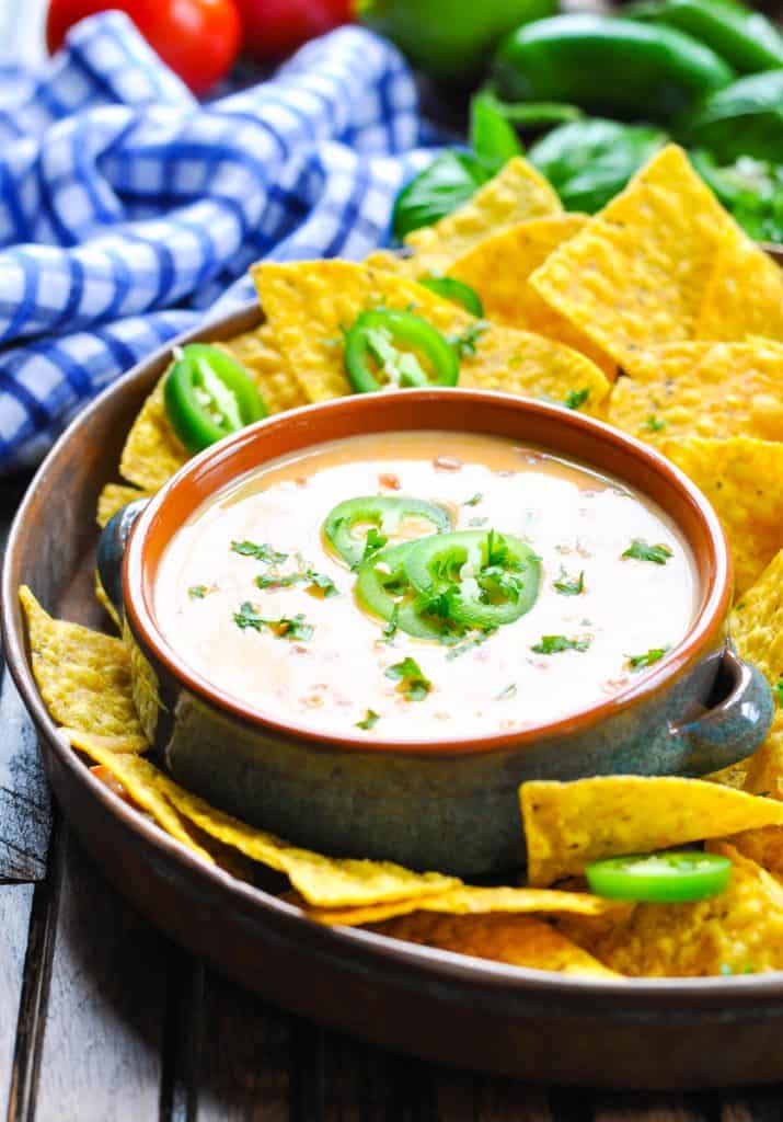 Velveeta queso dip garnished with jalapeno peppers and cilantro