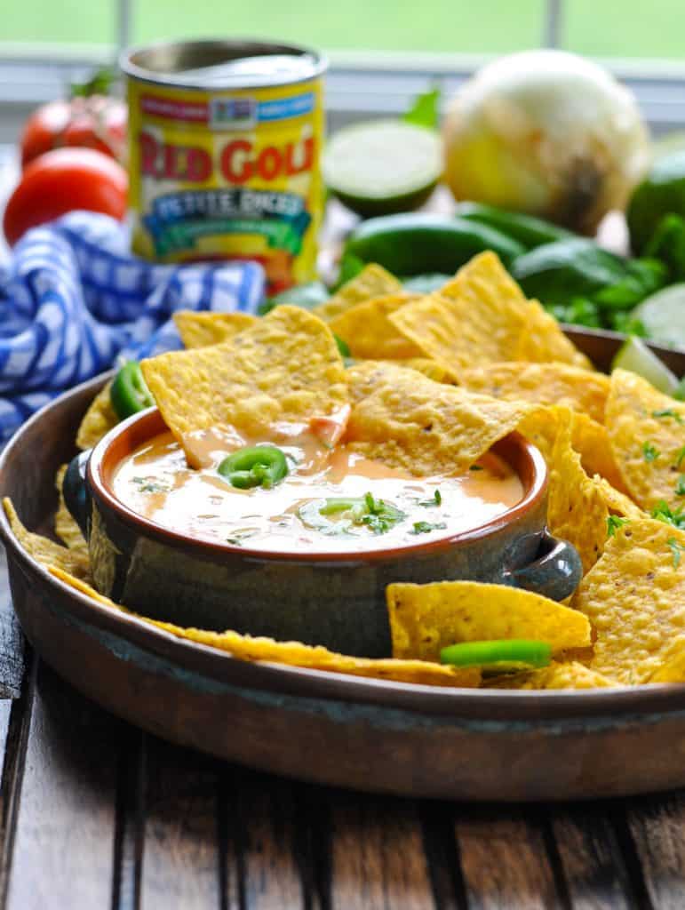 Tray of tortilla chips served with spicy queso dip