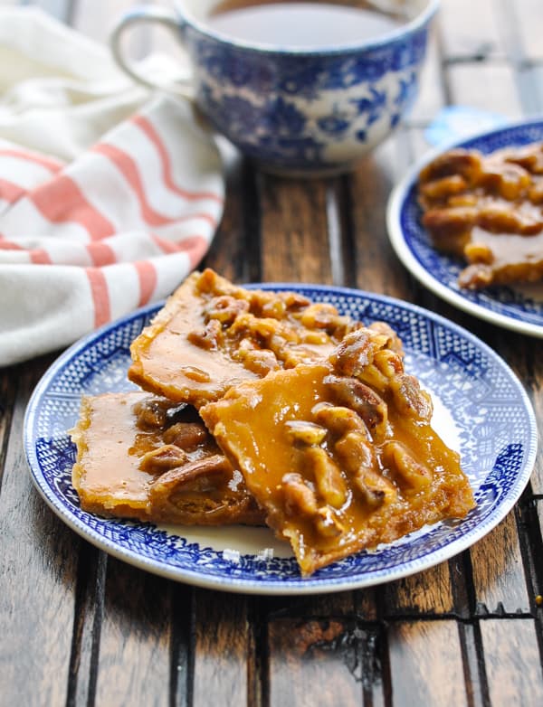 Close up image of pecan brittle graham cracker toffee bars on a plate