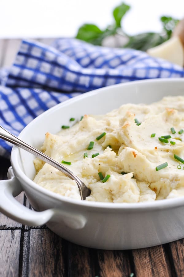 White casserole dish with garlic mashed potatoes