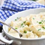 Garlic mashed potatoes with cream cheese and sour cream in white baking dish