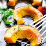 Slices of roasted acorn squash for an easy side dish with text