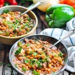 Bowls of slow cooker cowboy pork and beans with ground beef and text overlay