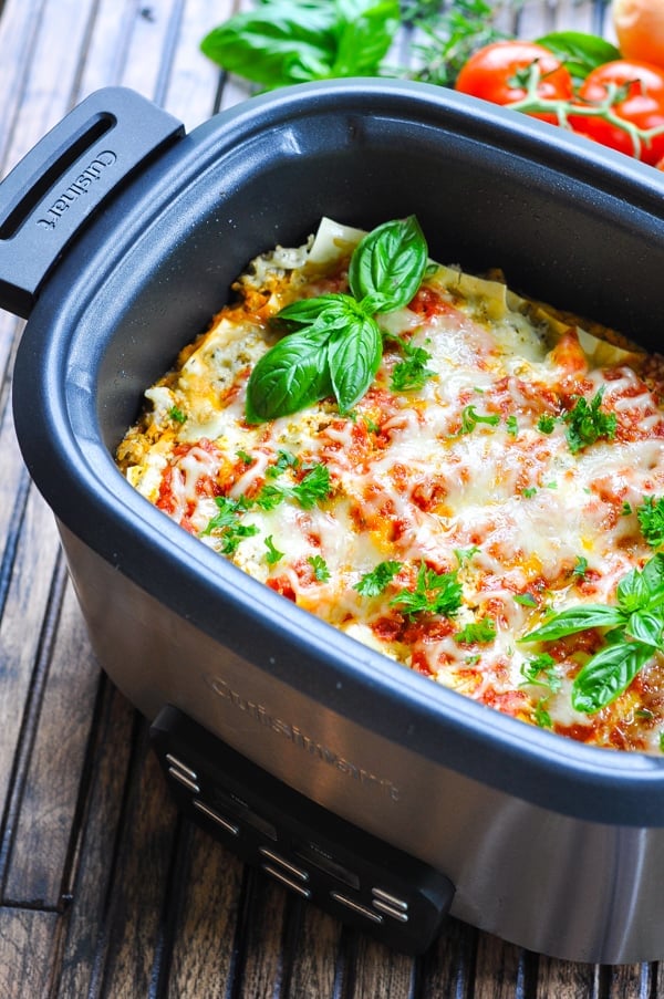 Slow cooker lasagna garnished with basil and parsley