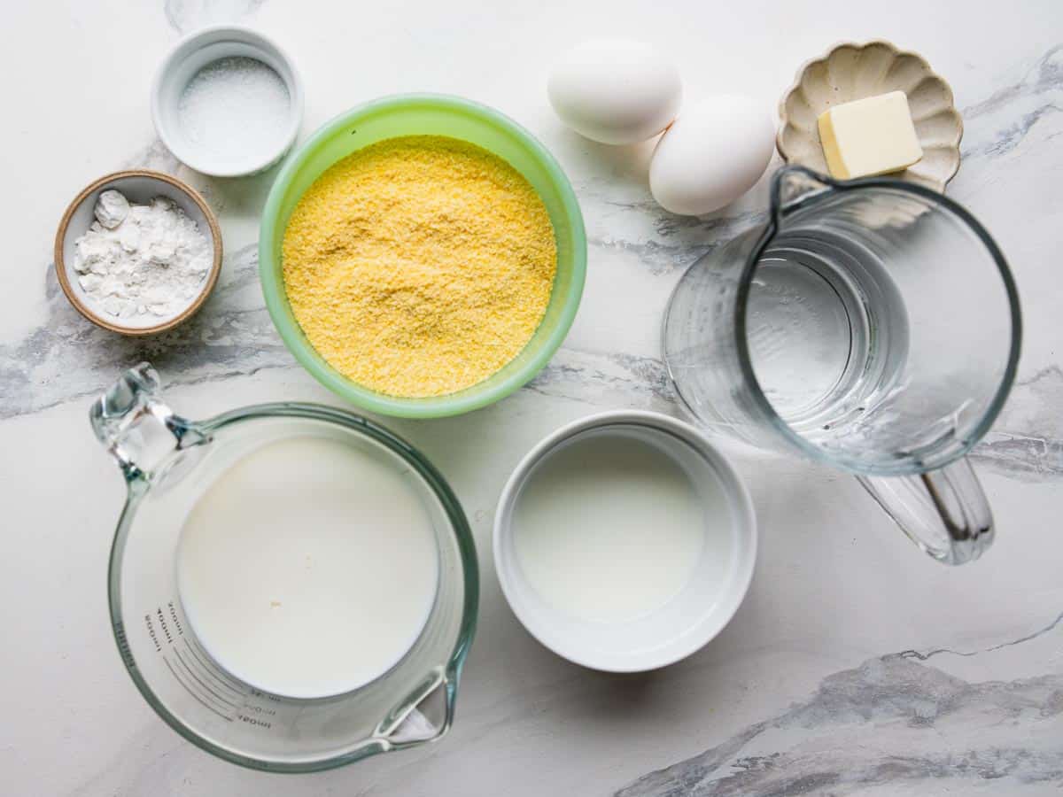 Spoon bread ingredients on a white table.