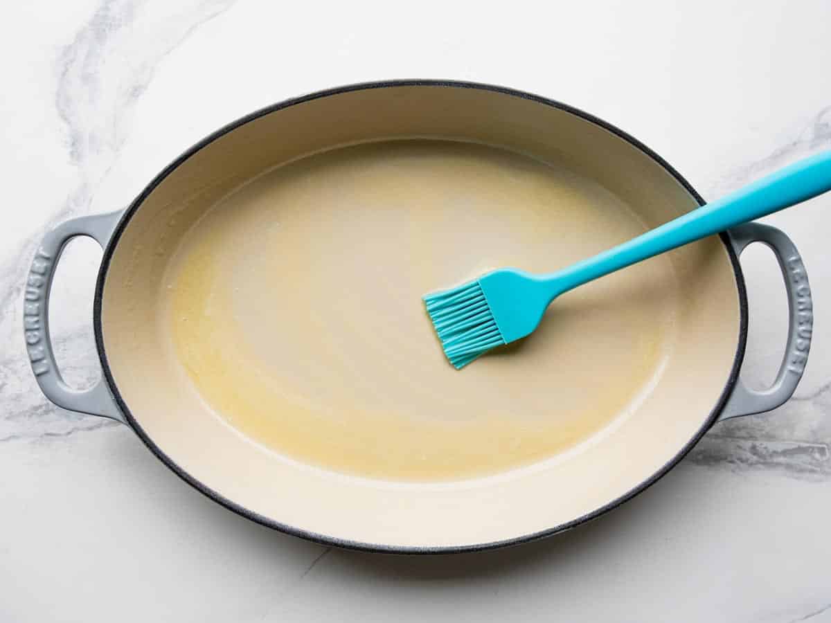 Greasing a cast iron pan with butter.