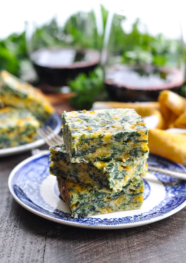 Cheesy Spinach Squares on a blue and white appetizer plate