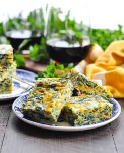 Side shot of a plate of spinach cheese squares.