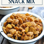 Side shot of a bowl of homemade snack mix with text title box at top