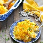 Hash brown casserole on a blue and white plate with text overlay