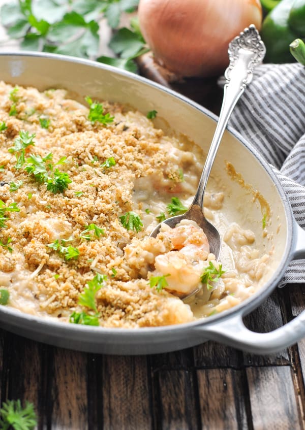 Shrimp and rice casserole in a baking dish with serving spoon