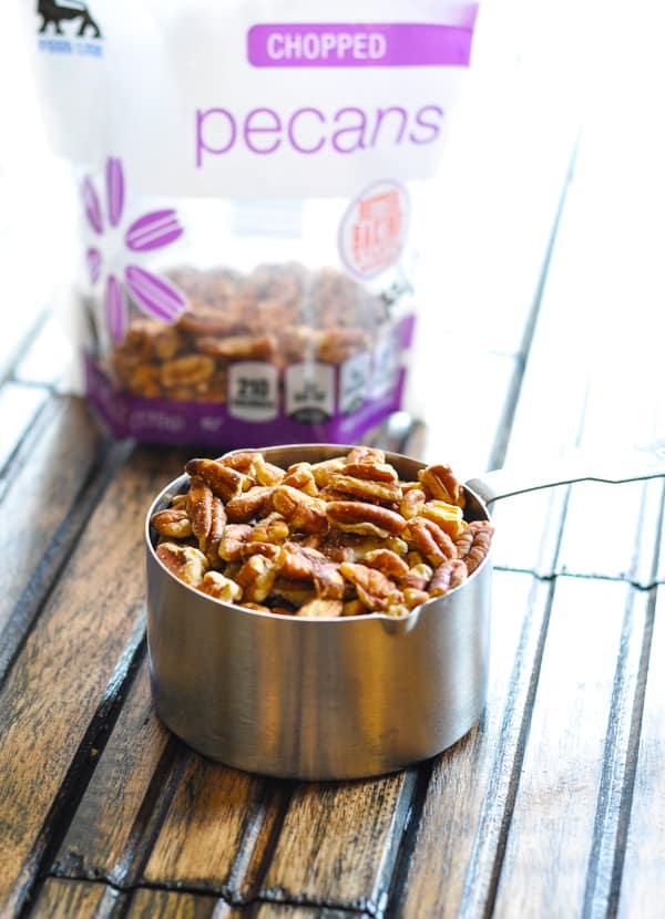 Chopped pecans in measuring cup