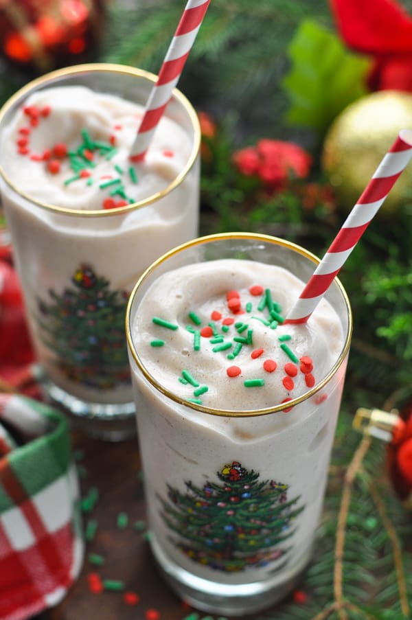 Two glasses of gingerbread cookie protein smoothie recipe with christmas sprinkles on top