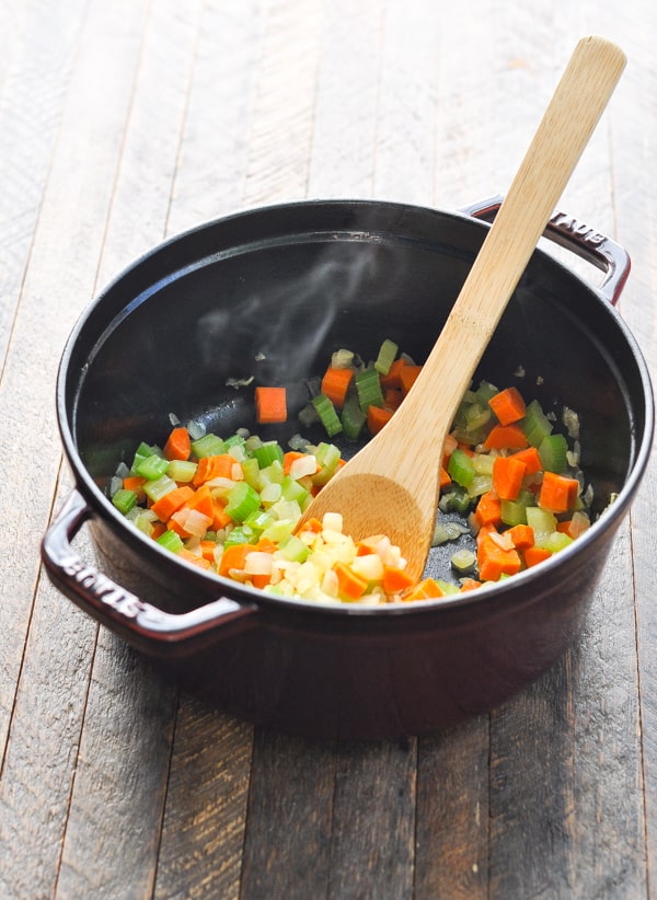 Carrots onion and celery in a pot for turkey noodle soup