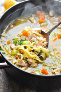 Ladle in a pot of leftover turkey noodle soup without carcass