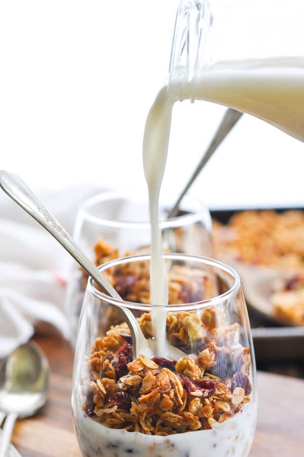 Pouring milk over homemade easy granola recipe
