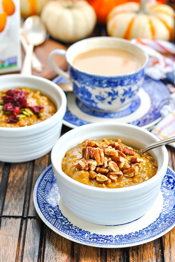 Bowls of pumpkin spice slow cooker oatmeal garnished with pecans