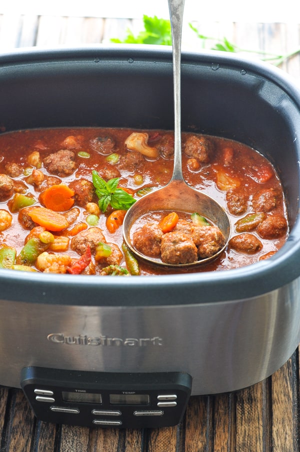 Italian meatball stew in slow cooker with ladle