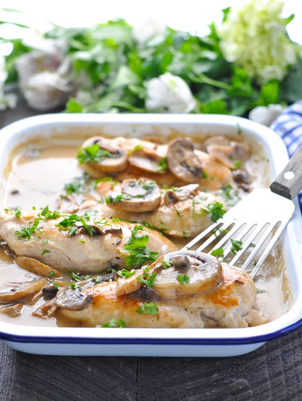 Baked chicken breasts in a creamy mushroom sauce in a baking dish