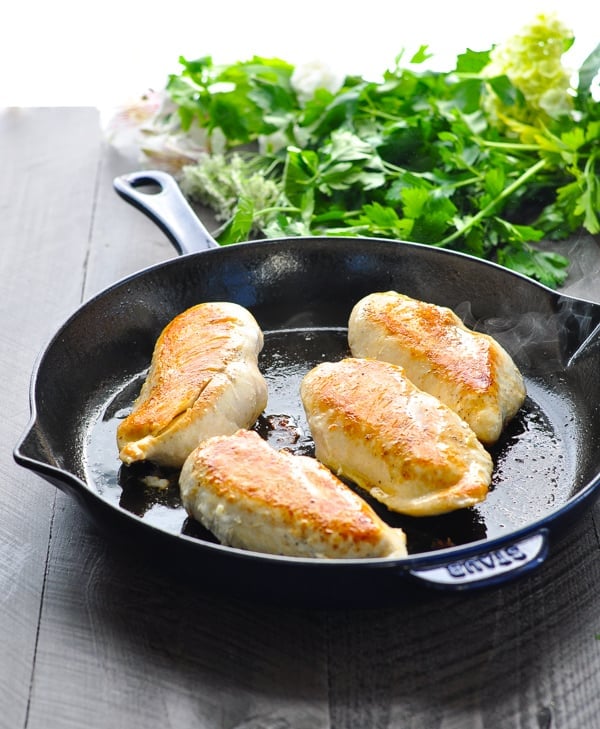 Browned chicken breasts in cast iron skillet