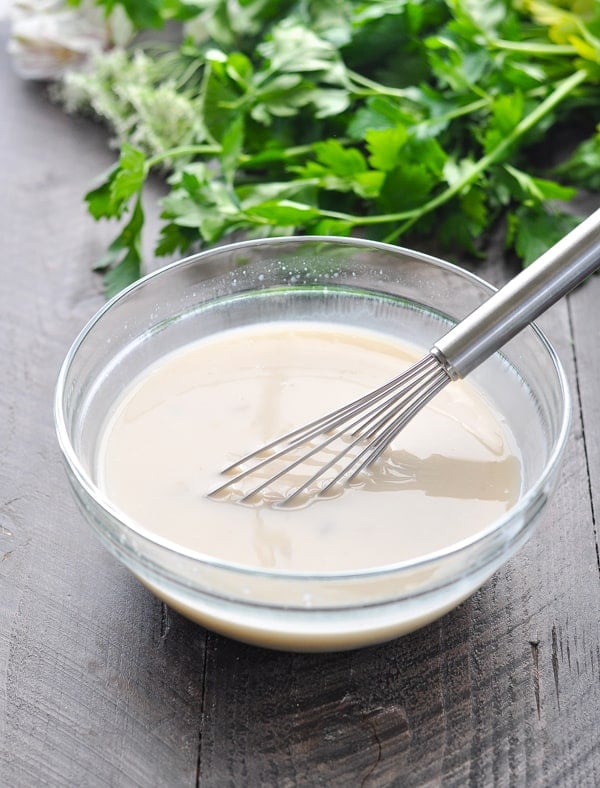 Creamy mushroom sauce with whisk in glass mixing bowl