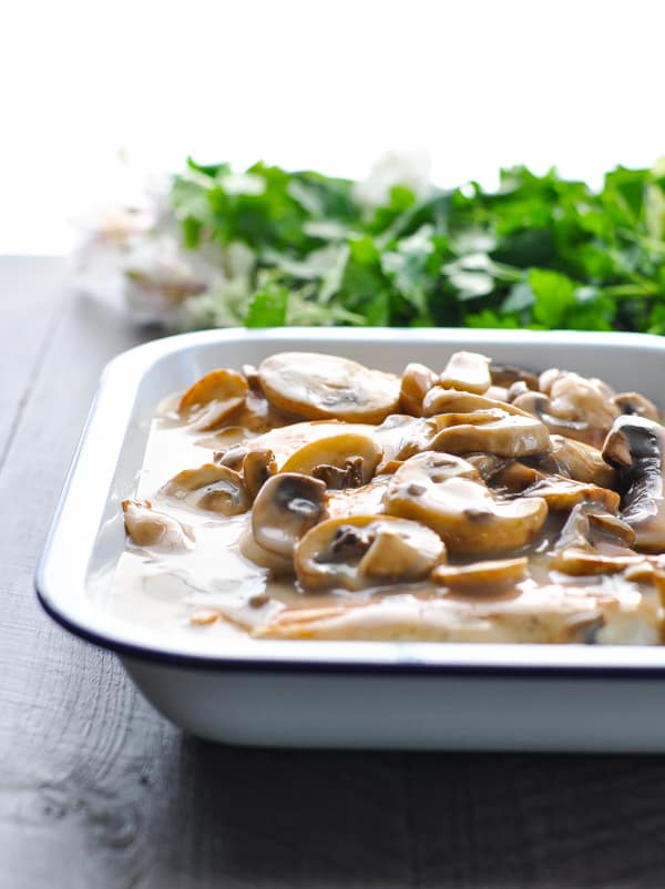 Poured mushroom sauce over chicken breasts in baking dish