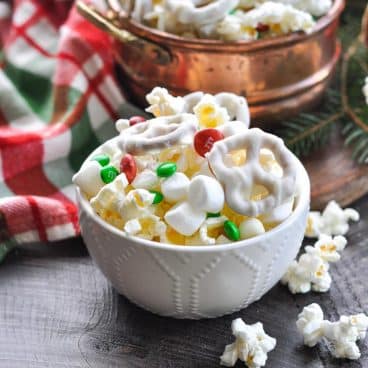 Square side shot of a bowl of easy Christmas snack mix.